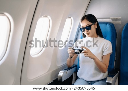 Asian woman sitting in a seat in airplane and looking out the window going on a trip vacation travel concept.Capture the allure of wanderlust with this stunning image
