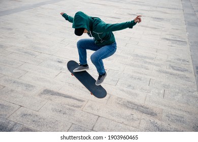 Asian woman skateboarder skateboarding in modern city - Shutterstock ID 1903960465