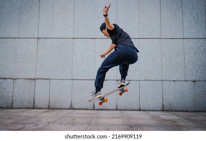 Asian woman skateboarder skateboarding in modern city - Shutterstock ID 2169909119