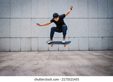 Asian woman skateboarder skateboarding in modern city - Shutterstock ID 2173521455