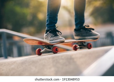 Asian Woman Skateboarder Skateboarding At Skatepark