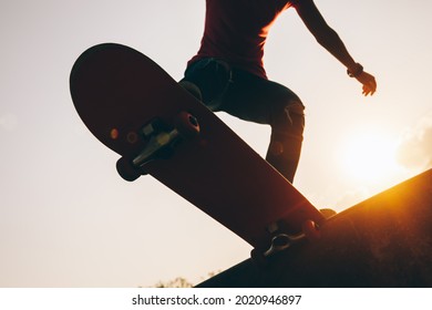 Asian Woman Skateboarder Skateboarding At Skatepark