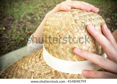 Asian woman sleeping holding straw hut