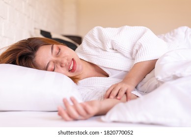 Asian Woman Sleeping On The Bed And Grinding Teeth,Female Tiredness And Stress