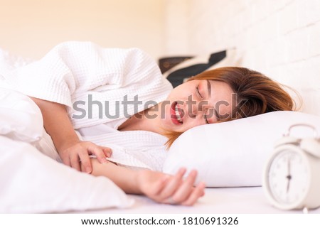 Asian woman sleeping on the bed and grinding teeth,Female bruxism,Gnash or clench your teeth
