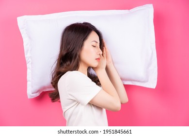 Asian Woman Sleeping On Pink Background
