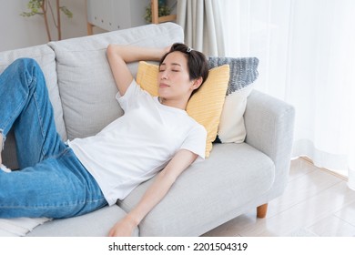 Asian Woman Sleeping On Sofa