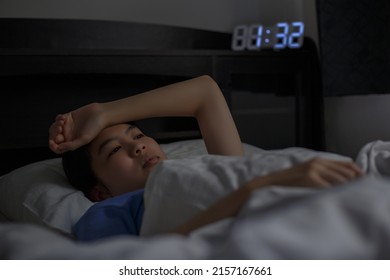 Asian woman sleepless at night, Insomnia, Awake, Feeling frustrated, Worried, Stress, suffering from insomnia, Sleeping disorder concept. - Shutterstock ID 2157167661
