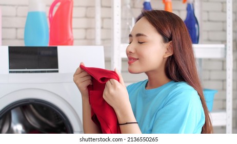 Asian Woman Smelling Clean Fresh Fabric And Fresh Laundry Scent.