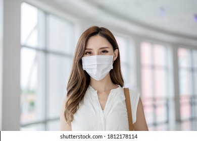 Asian Woman Smile To You With Surgical Mask Face Protection In The City