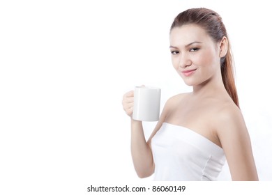 asian woman smiling to the camera before drinking from her cup