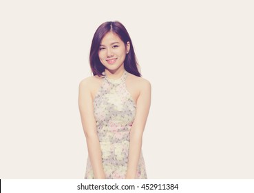 Asian woman smiling with dimple long hair black eyes on pastel pink background cute girl vintage style Beautiful Asian girl