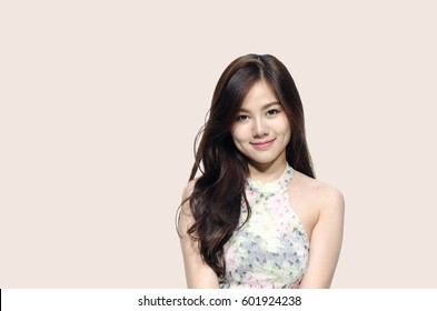 Asian woman smiling with dimple long hair black eyes on pastel pink background cute nice girl face vintage style Beautiful Asian girl with copy space