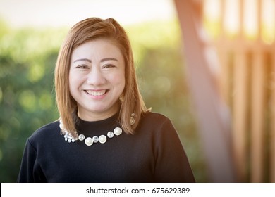 Asian Woman Smiling Happy Portrait With Sunlight . Beautiful Mature Middle Aged Thailand Asian Woman Closeup Beauty Portrait 