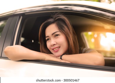 Asian woman smiling in her car,happy - Shutterstock ID 300501467