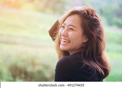 Asian woman smiling with perfect smile in the green nature