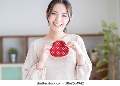 Asian Woman Smiling With A Wallet