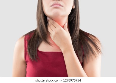 Asian Woman With A Sore Throat Or Thyroid Gland Against The Gray Background. Acid Reflux Or Heartburn, Neck Pain, People Body Problem Concept