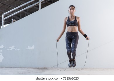 Asian Woman Sports Girl Doing Exercises With Jumping Rope.