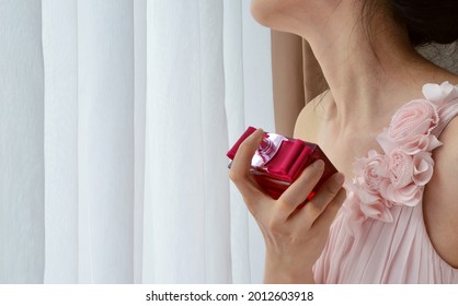 Asian Woman Spraying Perfume On Her Neck 