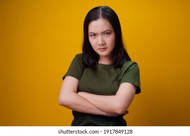 Asian Woman Standing And Angry Isolated Over Yellow Background.