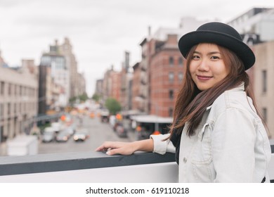 Asian Woman Standing Looking At Manhattan Street