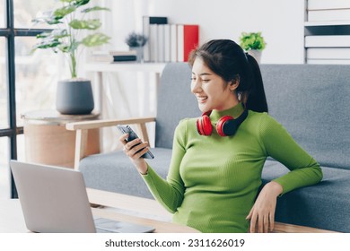 Asian woman stay at home with education time.Young female student relax learning via internet online technology by laptop computer. - Shutterstock ID 2311626019