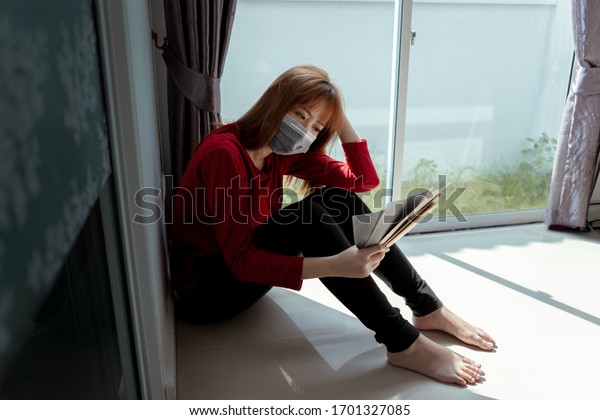 Asian
woman stressed due to the outbreak crisis of the coronavirus,
causing unemployment and lack of funds for debt settlement, stay at
home self isolation from society to reduce
risks.
