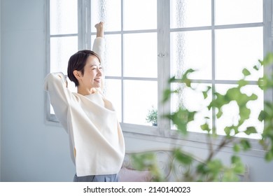 Asian Woman Stretching With A Smile