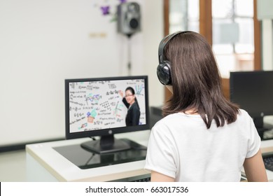 Asian woman student video conference e-learning with teacher on computer in IT room at university. E-learning ,online ,education concept