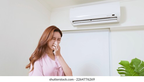 asian woman is suffering from air conditioner musty bad stinky smell