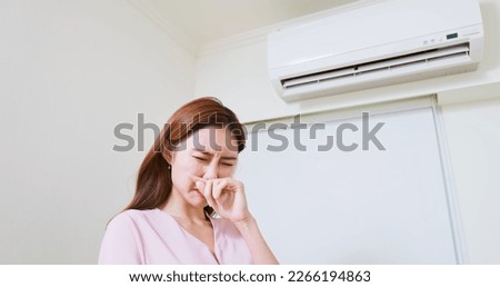 asian woman is suffering from air conditioner musty bad stinky smell