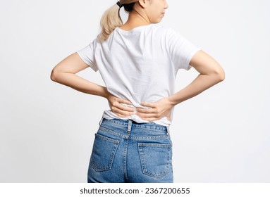 Asian woman suffering from back pain from sitting for a long time, Office Syndrome. - Shutterstock ID 2367200655