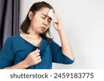 asian woman suffering from hot weather feeling tired and vertigo because of heat wave in summer 