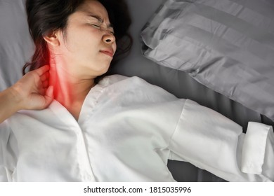 
Asian Woman Suffering From Neck Sprain Or A Crick In Her Neck During Sleeping In The Bed 