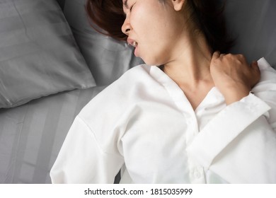 
Asian Woman Suffering From Neck Sprain Or A Crick In Her Neck During Sleeping In The Bed 