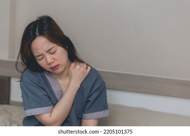 Asian Woman Suffering From Pain In Shoulder And Neck Tension At Home