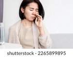 Asian woman suffering from stuffy nose having runny nose and bad breath caused by sinus infection 