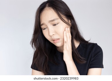 Asian woman suffering from toothache, tooth decay, tooth sensitivity, wisdom tooth pain, cavity, dental care concept - Shutterstock ID 2320239983