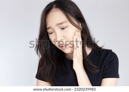 Asian woman suffering from toothache, tooth decay, tooth sensitivity, wisdom tooth pain, cavity, dental care concept