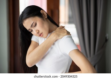 Asian Woman Suffers From Shoulder Joint Pain Or Injury