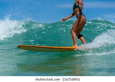 Asian Woman Surfer Surfing And Riding Surfboard  The Wave In The Sea At Tropical Beach In Sunny Day. Healthy Female Enjoy Outdoor Activity Lifestyle And Water Sport Exercise Surfing On Summer Vacation