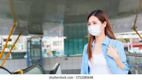 Asian woman with surgical face mask protection - she commutes in the metro or train station - Powered by Shutterstock