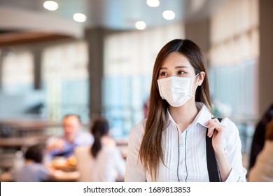 Asian Woman With Surgical Mask Face Protection Walking In Crowds At Restaurant Or Shopping Mall