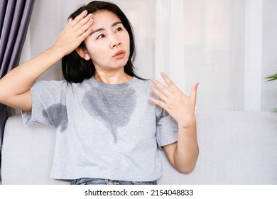 Asian woman sweating because of hot weather, menopause symptom concept  - Shutterstock ID 2154048833