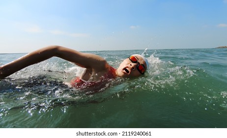 Asian Woman Is Swimming In Water Training For Triathlon At Beach