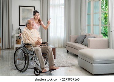 Asian Woman Take Care Her Grandfather In Family Room, Old Man On Wheelchair With Nurse