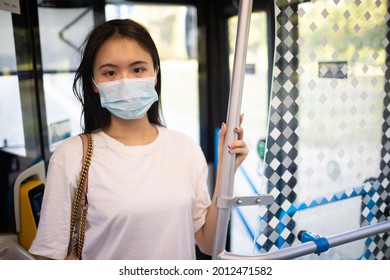 Asian Woman Take A Ride Stand In Public Transport Bus Or Tram With Face Mask