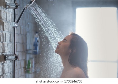 Asian woman takes a shower and she feels relaxed.