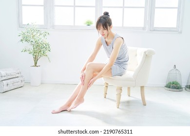 Asian Woman Taking Care Of Her Foot At Home